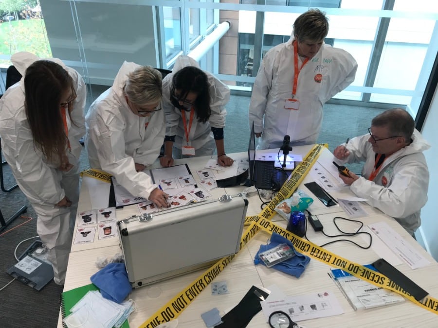 Forensic investigation workshop with participants in protective suits