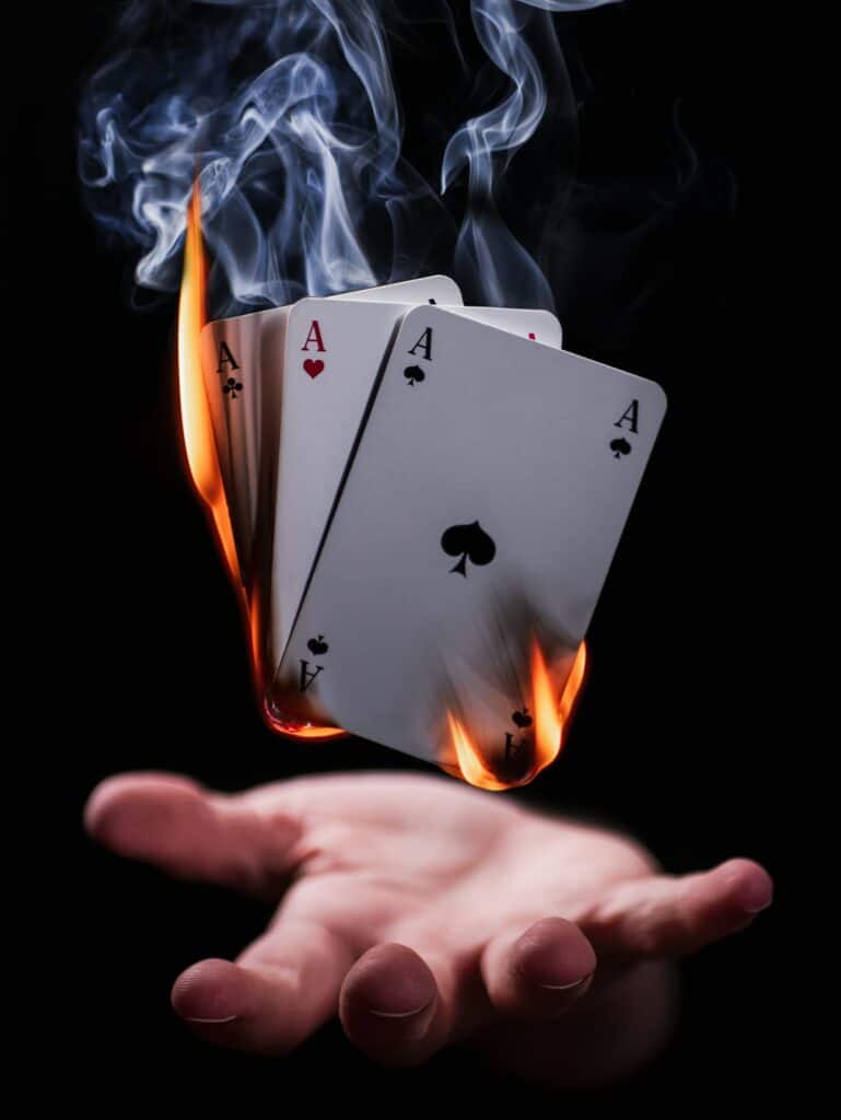 Magician performing a fire card trick at a magic workshop