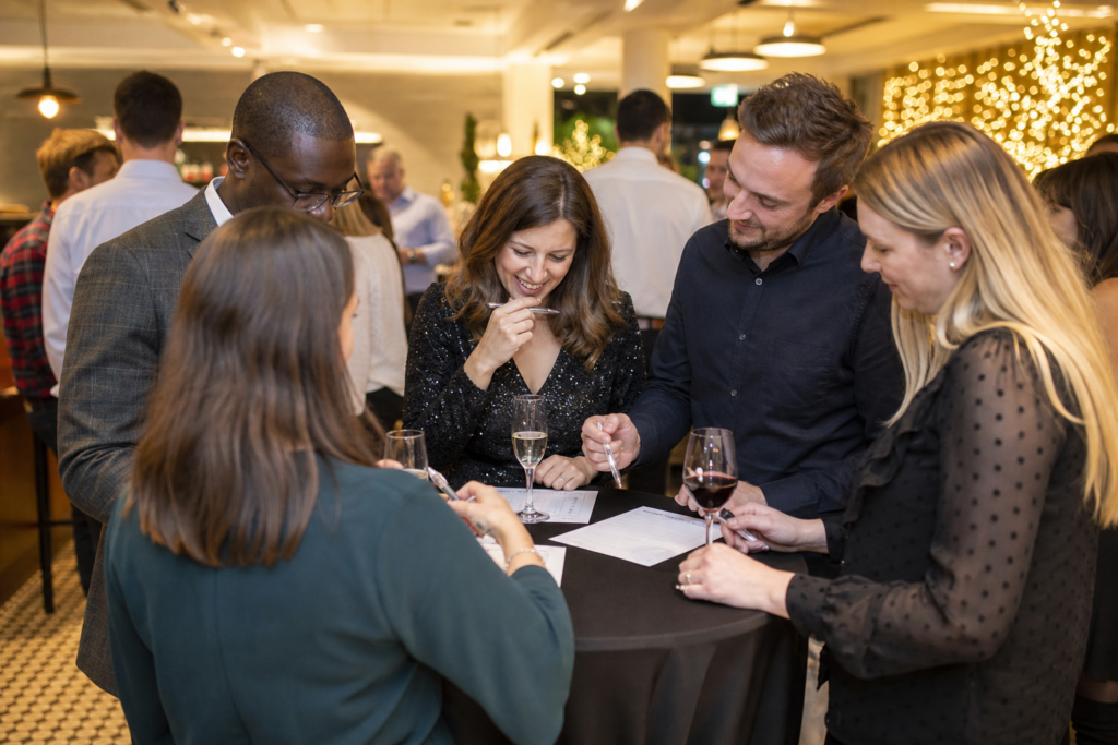Colleagues playing an indoor office party quiz game