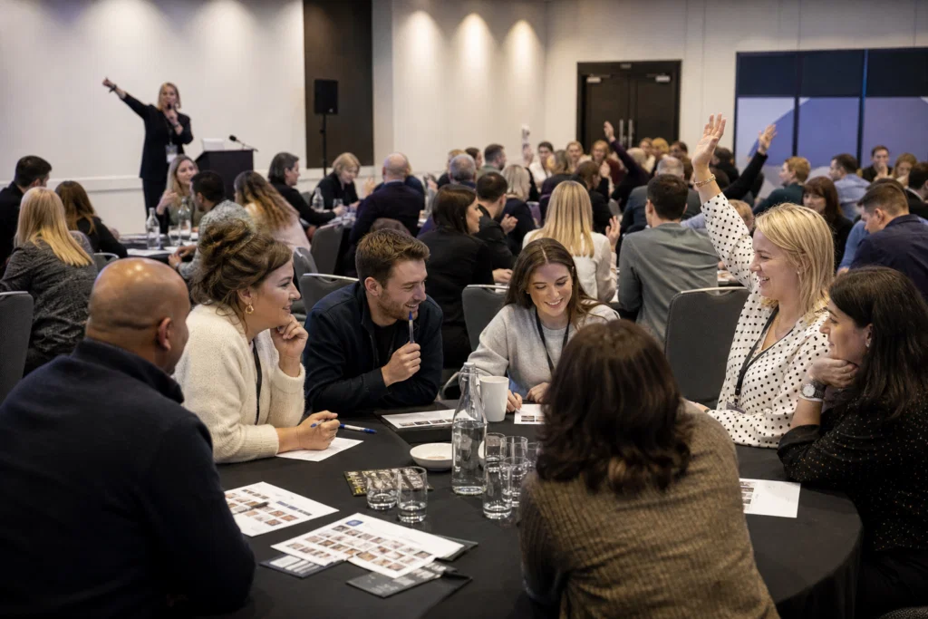 Conference delegates taking part in a table quiz energiser