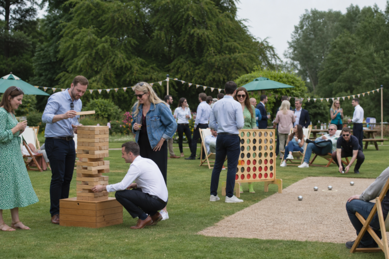 UK corporate team enjoying a hosted garden party with giant lawn games on a summer lawn