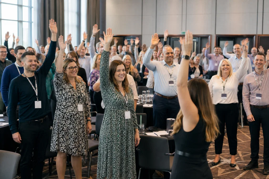 Large conference audience taking part in an icebreaker activity