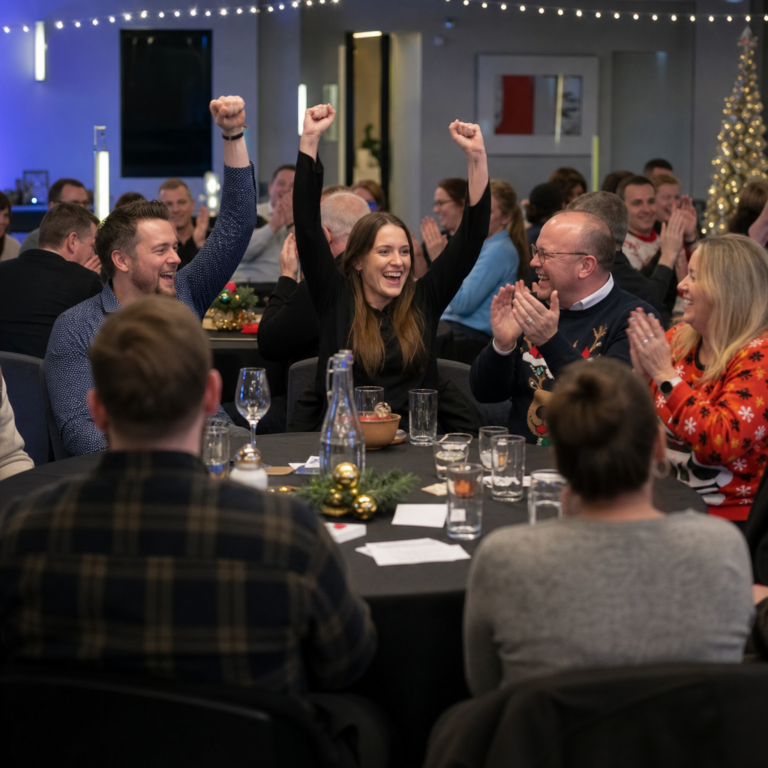 Winning team celebrating at the end of a festive corporate quiz