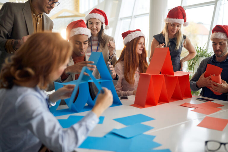 People,At,Office,Competing,In,Building,Card,Towers,With,Santa