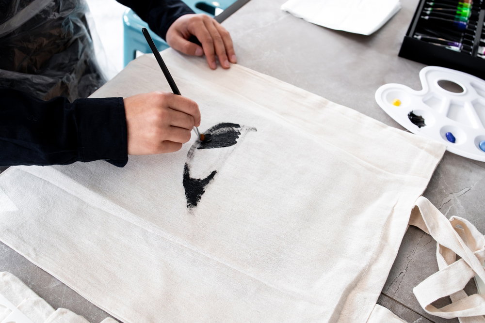 Person,Painting,Design,On,Canvas,Bag,With,Black,Brush,Strokes