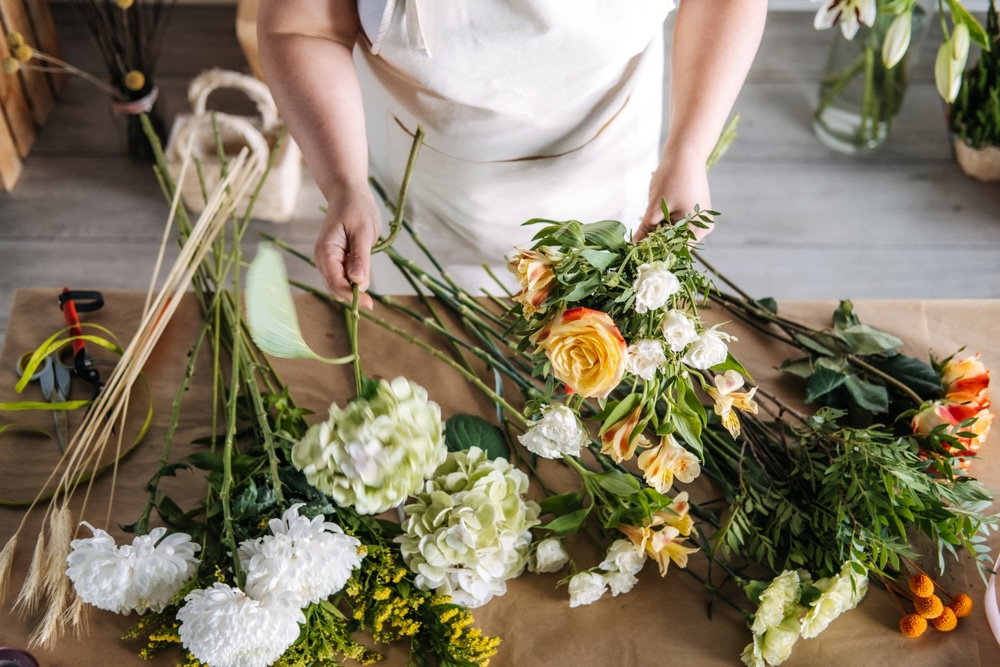 Woman,Assembling,A,Bouquet,With,Yellow,Rose,And,Greenery,In