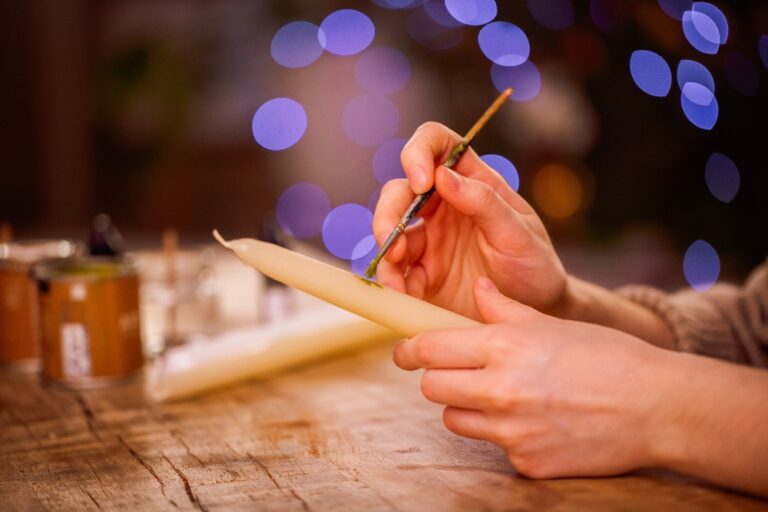 Creative,Hands,Are,Painting,A,Candle,With,Bright,Colors,,Surrounded